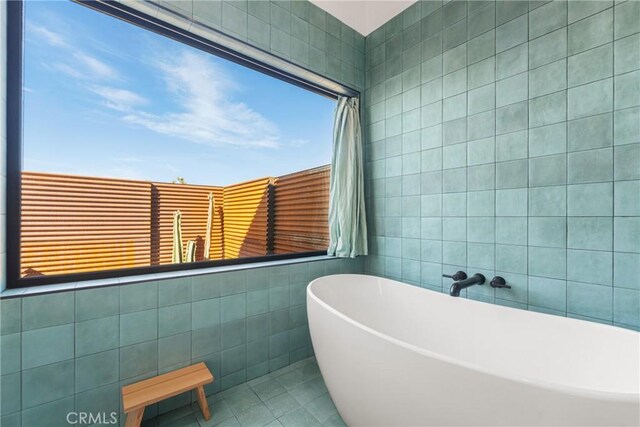3170 Wesley Rd, Joshua Tree, CA 92252 - full bathroom featuring tile walls, a soaking tub, and tile patterned floors