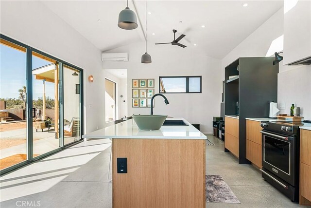 3170 Wesley Rd, Joshua Tree, CA 92252 - kitchen with electric range, a ceiling fan, modern cabinets, a kitchen island with sink, and an AC wall unit