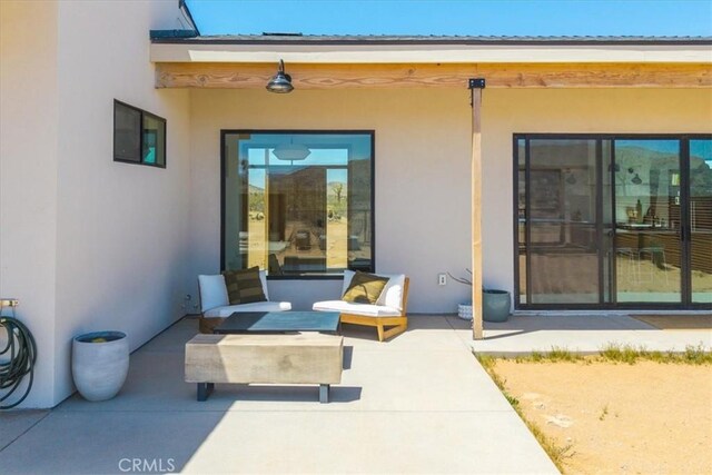 3170 Wesley Rd, Joshua Tree, CA 92252 - doorway to property with stucco siding and a patio