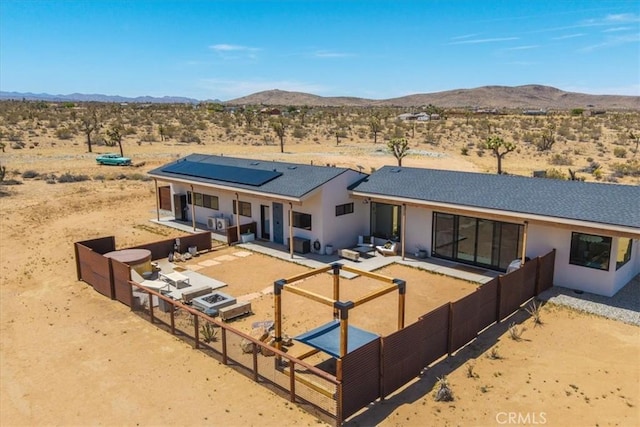 3170 Wesley Rd, Joshua Tree, CA 92252 - back of property with view of desert landscape, a mountain view, a patio, and a fenced backyard