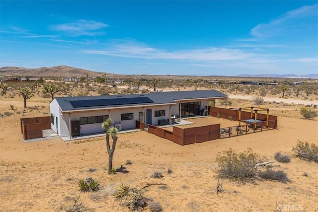 3170 Wesley Rd, Joshua Tree, CA 92252 - back of property featuring a desert view, a mountain view, roof mounted solar panels, and a rural view