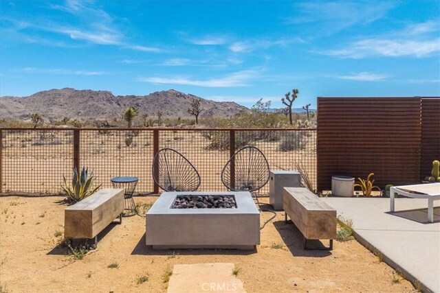 3170 Wesley Rd, Joshua Tree, CA 92252 - view of patio / terrace with an outdoor fire pit and a mountain view