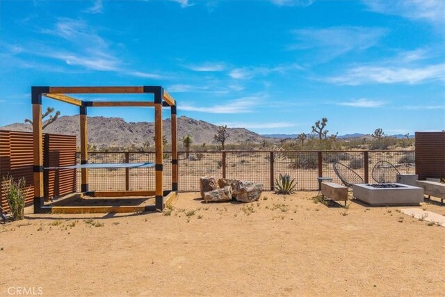 3170 Wesley Rd, Joshua Tree, CA 92252 - view of yard with a mountain view and an outdoor fire pit