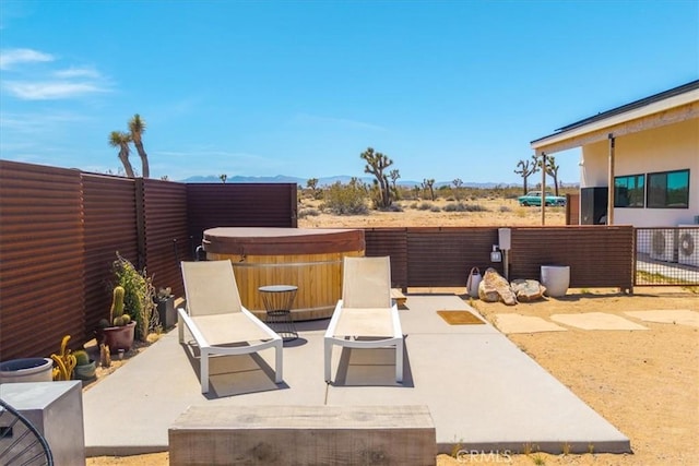 3170 Wesley Rd, Joshua Tree, CA 92252 - fenced backyard featuring a hot tub, a patio, and a mountain view
