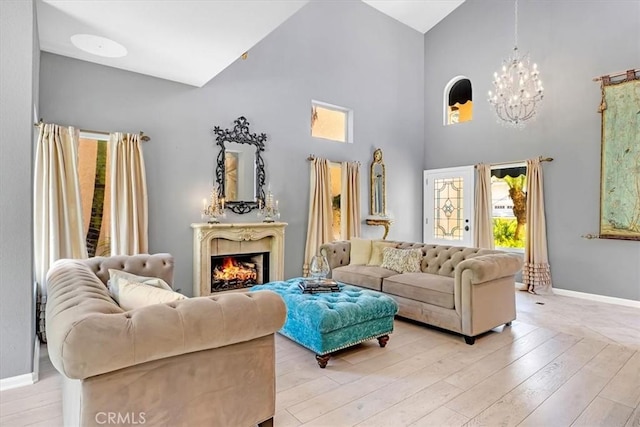 9 Gema, San Clemente, CA 92672 - living area featuring a chandelier, high vaulted ceiling, baseboards, and light wood-style flooring
