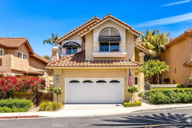 9 Gema, San Clemente, CA 92672 - mediterranean / spanish home with a garage, concrete driveway, a tiled roof, and stucco siding