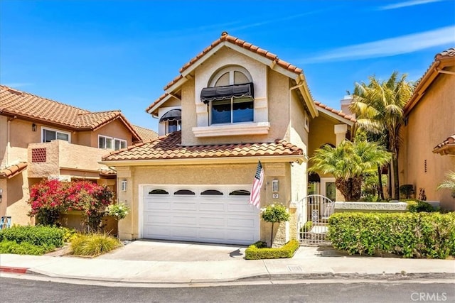 9 Gema, San Clemente, CA 92672 - view of front facade with a tile roof, a garage, driveway, and stucco siding