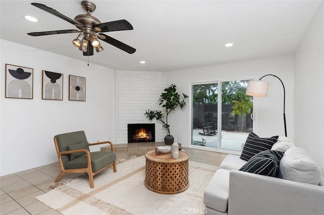 living room featuring tile patterned floors, a brick fireplace, recessed lighting, and ceiling fan