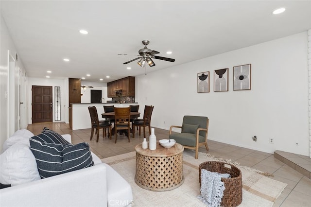 living area with ceiling fan, recessed lighting, baseboards, and light tile patterned floors