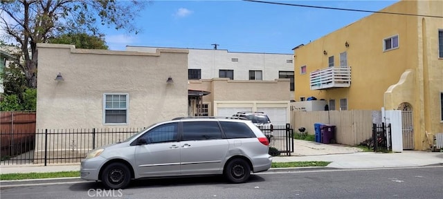 view of property with a garage and fence