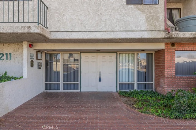 7211 Cozycroft Ave Unit 19, Winnetka, CA 91306 - doorway to property featuring brick siding and stucco siding