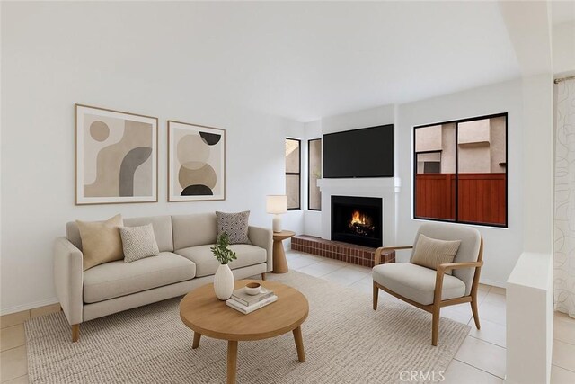 7211 Cozycroft Ave Unit 19, Winnetka, CA 91306 - living room featuring light tile patterned floors, healthy amount of natural light, a warm lit fireplace, and baseboards
