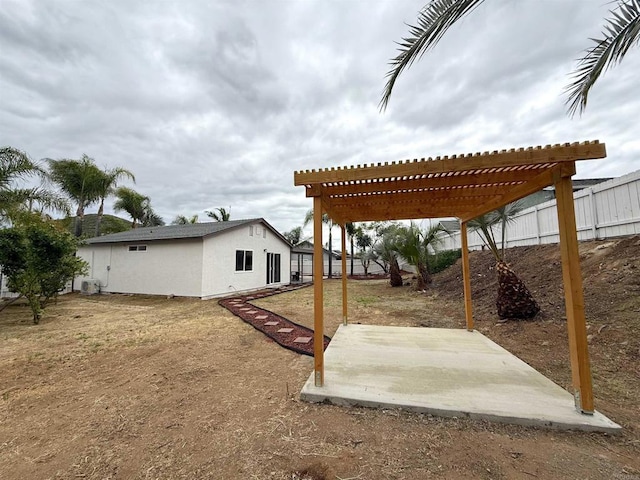 view of yard featuring a pergola, a fenced backyard, central AC, and a patio