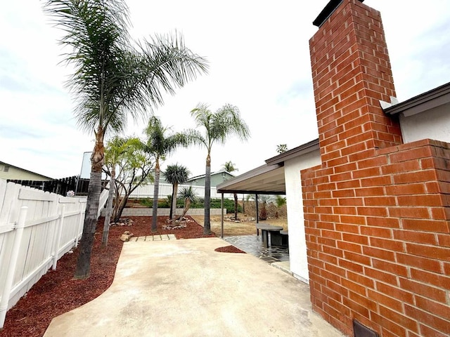 view of patio / terrace featuring fence