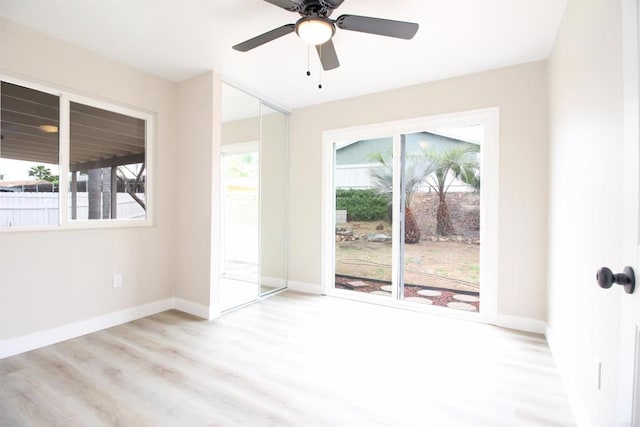unfurnished room with ceiling fan, baseboards, and wood finished floors