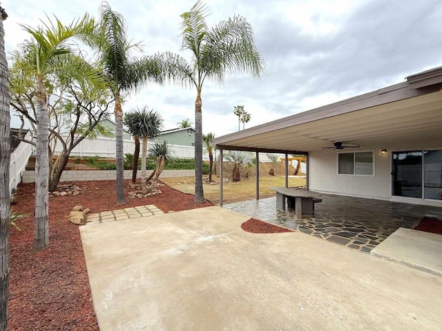 view of patio with a fenced backyard and a ceiling fan