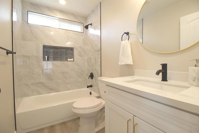 bathroom with toilet, shower / bathtub combination, and vanity