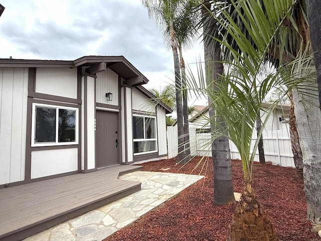 exterior space featuring fence and a deck