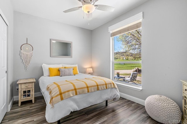 bedroom with ceiling fan, baseboards, wood finished floors, and a closet