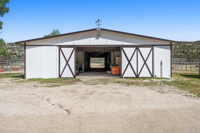 view of pole building with fence