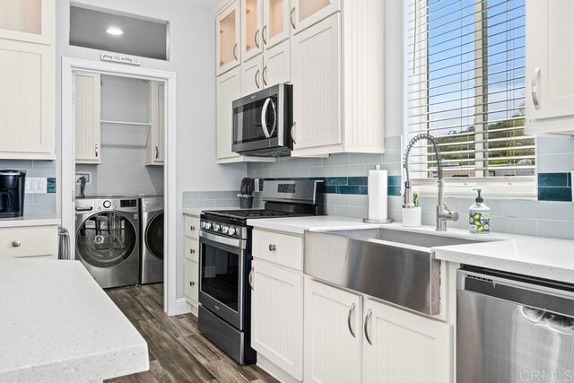 2815 Miller Valley Rd, Pine Valley, CA 91962 - kitchen with appliances with stainless steel finishes, washer and dryer, a sink, decorative backsplash, and dark wood-style flooring