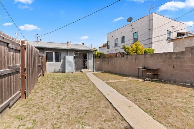 1515 S Walker Ave, San Pedro, CA 90731 - rear view of property featuring a lawn and a fenced backyard
