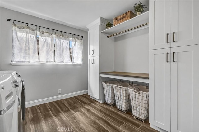 laundry area featuring cabinet space, baseboards, washing machine and clothes dryer, and dark wood-style floors