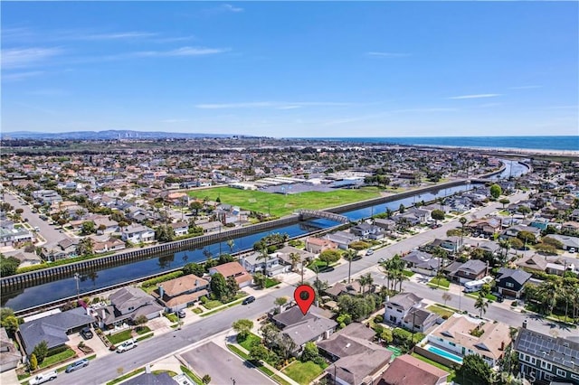 drone / aerial view featuring a residential view and a water view