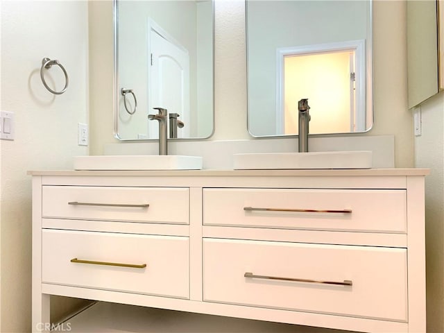 bathroom featuring double vanity and a sink