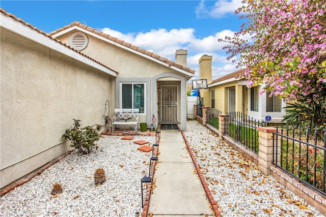 916 Award Dr, Colton, CA 92324 - property entrance with stucco siding and a chimney