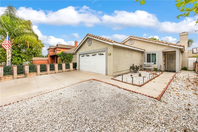 916 Award Dr, Colton, CA 92324 - view of front of home with a garage, stucco siding, concrete driveway, a chimney, and a tiled roof