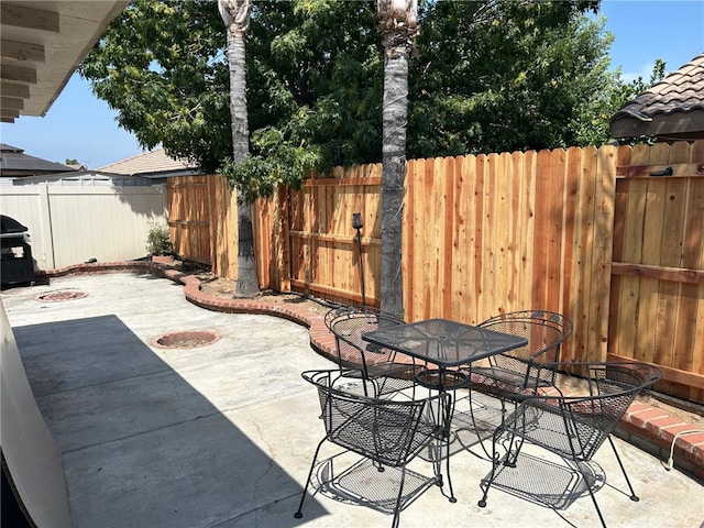 916 Award Dr, Colton, CA 92324 - fenced backyard featuring a patio, outdoor dining area, and grilling area