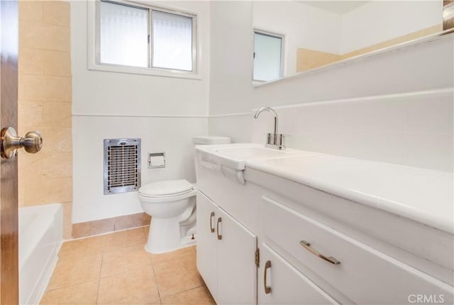 full bath with tile patterned floors, toilet, baseboards, heating unit, and vanity
