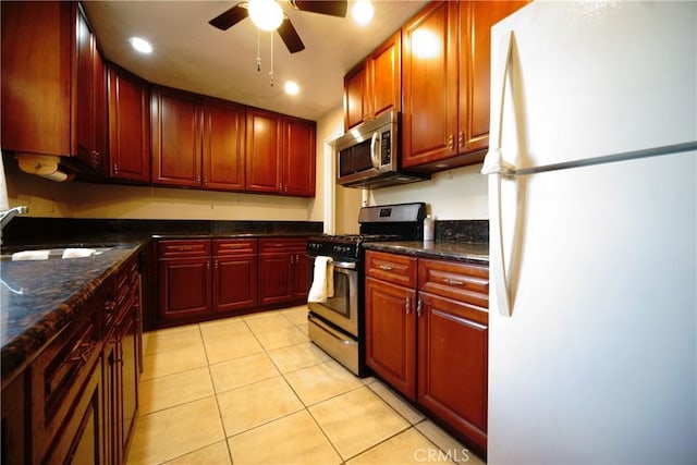 73203 Sun Valley Dr Unit 29, Palms, CA 92277 - kitchen featuring stainless steel appliances, dark brown cabinets, light tile patterned floors, and a ceiling fan