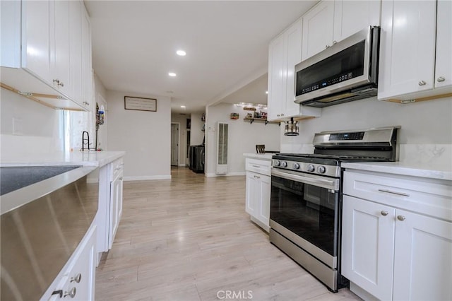 1924 Hunter Rd, Colton, CA 92324 - kitchen with appliances with stainless steel finishes, white cabinets, light wood finished floors, recessed lighting, and light countertops