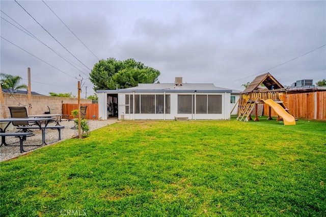 1924 Hunter Rd, Colton, CA 92324 - rear view of house with a sunroom, a fenced backyard, and a playground