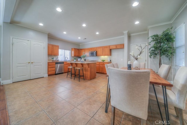 dining space with recessed lighting, ornamental molding, and light tile patterned floors