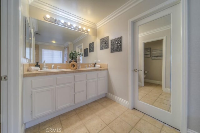 bathroom featuring crown molding, double vanity, a sink, and tile patterned flooring