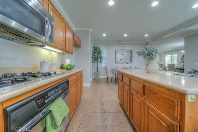 kitchen with light countertops, appliances with stainless steel finishes, ornamental molding, and recessed lighting