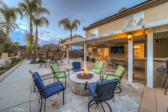 view of patio / terrace featuring ceiling fan, a fenced backyard, french doors, an outdoor fire pit, and outdoor dining space