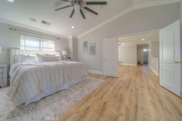 bedroom with visible vents, crown molding, vaulted ceiling, light wood-type flooring, and baseboards