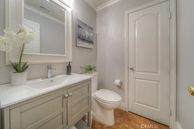 bathroom featuring crown molding, toilet, visible vents, and vanity