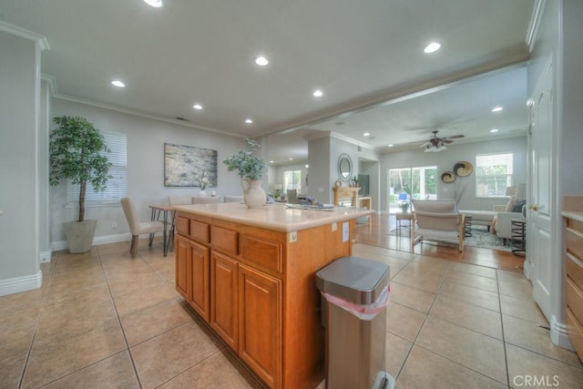 kitchen featuring crown molding, recessed lighting, and light tile patterned floors