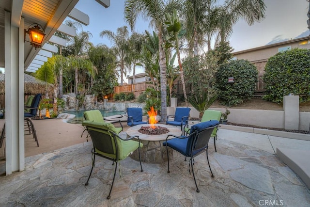 view of patio featuring a fenced backyard and an outdoor fire pit