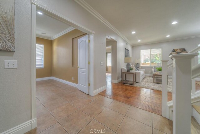 interior space with crown molding, recessed lighting, baseboards, and light tile patterned floors