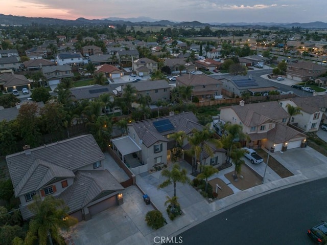 aerial view at dusk with a residential view and a mountain view