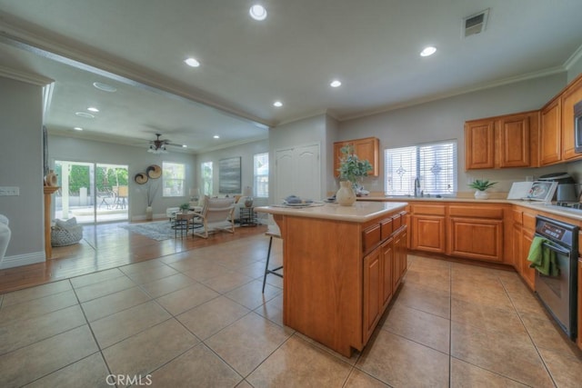 kitchen with crown molding, oven, open floor plan, and light tile patterned floors