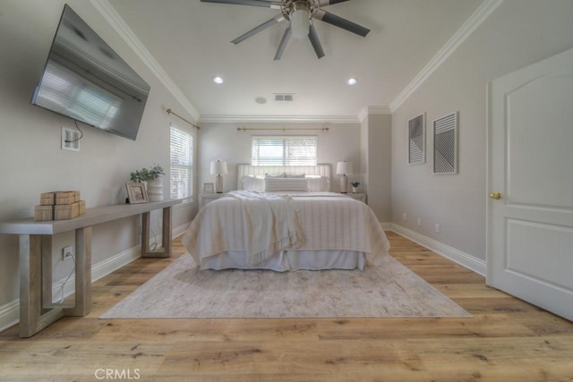 bedroom with visible vents, light wood-style flooring, baseboards, and crown molding
