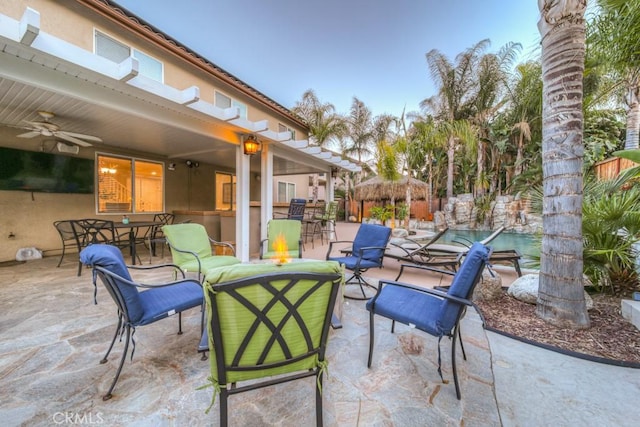 view of patio with outdoor dry bar and ceiling fan