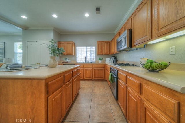 kitchen featuring light countertops, appliances with stainless steel finishes, a healthy amount of sunlight, and visible vents